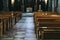 Passage of a church with empty wooden benches