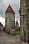 Passage in the city defense wall of Tallinn. On the roofs of the towers red tile.