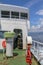 Passage through the covered ferry deck along the edge of ship. White steel boat for transporting people and vehicles. Ferry.