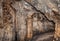 Passage in a deep cave. Stone block wall.