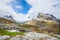 Passage in the mountains with snowy peaks around Alnesvatnet lake panorama, path of trolles, Trollstigen, Rauma Municipality, More