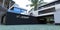 Through passage to the courtyard of an advanced new building. Stone blocks from natural granite. Large palm tree in the background