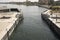 Passage of a tourist cruise through the lock of the Nile River at the height of the city of Esna in Egypt, Africa.