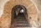 Passage between two parts of the ancient castle with an old stone staircase. Stone arch and steps in the castle. Stone corridor