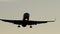 Passenger aircraft landing Close up. Passenger airplane landing towards the runway during sunset. Wheels touchdown close