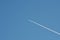 Passenger aircraft vapor trail on blue summer sky