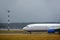 The passenger airliner landed on the airport runway in bad weather with rain