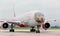 Passenger airplane Boeing 777-300 of Rossiya Airlines on the runway. Fuselage is painted as a face of Far Eastern leopard.