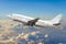 Passenger airplane flies in the sky gaining height above the clouds.