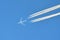 Passenger airplane in flight - blue sky - 4 engine plane - engine contrails - chemtrails