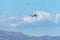 Passenger airplane flying above a mountain against the blue sky