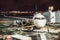 Passenger airplane on runway near the terminal in an airport at night time. Airport land crew doing flight service for passenger a