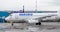 Passenger airplane Sukhoi Superjet 100 SSJ 100 of IrAero company on airfield. Airport terminal on background