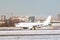 Passenger airplane taxing on runway for take off at daytime in winter day