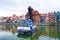 Passenger boat on the background of the historic embankment of Gdansk`s Main Town on the Motlawa River. Gdansk, Poland