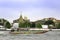 Passenger boats sail in the Chao Phraya River, passing in front of Wat Phra Kaew or Wat Phra Si Rattana Satsadaram