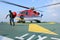 Passenger carry his baggage to embark helicopter at oil rig plat