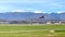 Passenger commercial jet airliner landing airport runway against against the background of snow covered glaciers of the peaks of t