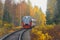Passenger diesel local train moves at autumn day time. Karelia
