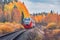 Passenger diesel local train moves to Sortavala at autumn day time. Karelia.