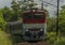 Passenger diesel red big train near Kysak station in summer hot morning