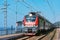 Passenger double deck train moves along the platform by the Black sea coast