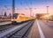 Passenger high speed train on the railway station at sunset