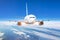 Passenger jet plane in the blue sky. Aircraft flying high through the cumulus clouds. Close up view airplane in flight