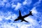 Passenger Jet Plane Silhouette on Cloudy Blue Sky