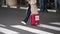 Passenger person carrying red suitcase with smoking banned sign, flight arrival.