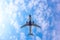 Passenger plane against the background of clouds the bottom view