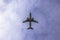 Passenger plane against the background of clouds the bottom view