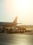 Passenger plane in the airport at sunrise.