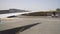 Passenger plane drive up to the airport terminal. View through the aircraft window at the runway