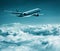 Passenger plane flies over cumulus clouds