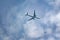 Passenger plane flies in the sky, bottom view.