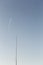 Passenger Plane Flying Through The Sky Above Telecommunications Tower