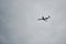 Passenger plane high up in the sky. Cloudy weather. Modern aviation