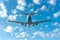 Passenger plane landing at airport with blue sky and white clouds, copy space available