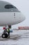 Passenger plane Qatar Airlines A7-ALW AIRBUS A350-900. Winter at the airport. A ladder for boarding passengers. Snow at