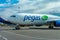 A passenger plane is standing at the airport in a parking space awaiting departure, the process of preparing for the flight is in