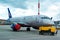 A passenger plane is standing at the airport in a parking space awaiting departure, the process of preparing for the flight is in