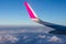 Passenger plane wing in the sky above the clouds. Round moon on the background of blue sky