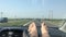 Passenger point of view on a vacation trip with bare feet on the dashboard.