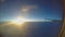 Passenger pov through plane window during flight. Aircraft flying above clouds