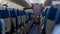 Passenger seat. Interior of airplane with passengers sitting on seats. Plane cabin. The interior of the aircraft with passengers o