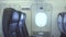 Passenger seats and emergency exit door inside commercial airplane. Interior modern passenger aircraft, passengers