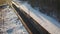 Passenger train traveling through a wooded area in a winter snowy season