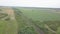 A passenger train travels by rail among autumn fields and meadows. Aerial photography by drone si and quadcopter from a bird`s eye