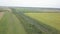 A passenger train travels by rail among autumn fields and meadows. Aerial photography by drone si and quadcopter from a bird`s eye